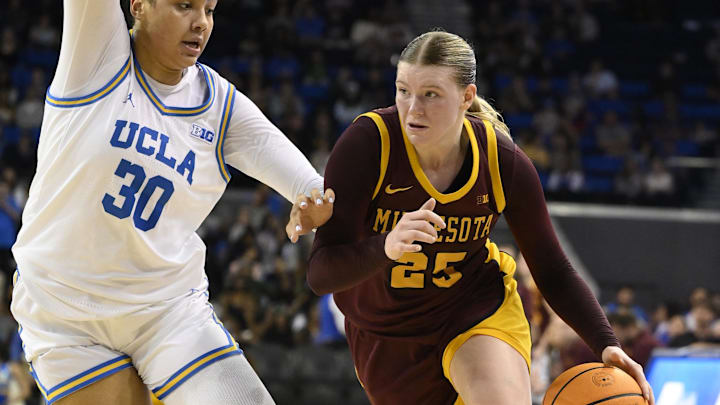 Feb 2, 2025; Los Angeles, California, USA; Minnesota Golden Gophers guard Grace Grocholski (25) drives to the basket as UCLA Bruins forward Timea Gardiner (30) defends during the seconds quarter at Pauley Pavilion presented by Wescom. Mandatory Credit: Robert Hanashiro-Imagn Images