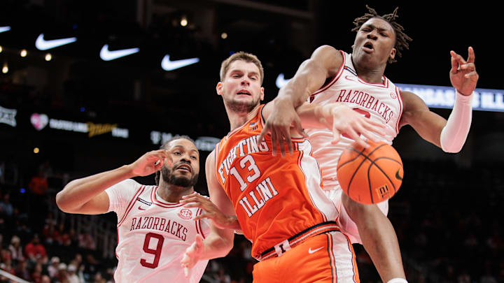 Nov 28, 2024; Kansas City, Missouri, USA; Arkansas Razorbacks forward Adou Thiero (3) and Illinois Fighting Illini center Tomislav Ivisic (13) get tangled up going after a rebound during the first half at T-Mobile Center. Mandatory Credit: William Purnell-Imagn Images