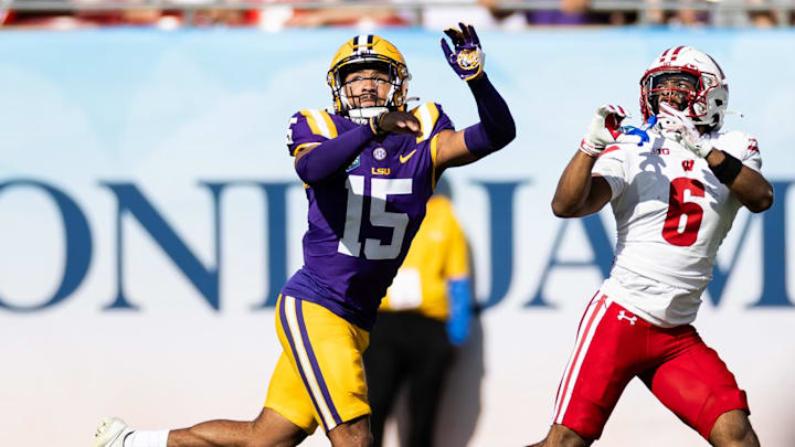 Jan 1, 2024; Tampa, FL, USA; LSU Tigers safety Sage Ryan (15) attempts to breakup a pass to Wisconsin Badgers wide receiver Will Pauling (6) during the first half at Raymond James Stadium. Mandatory Credit: Matt Pendleton-Imagn Images