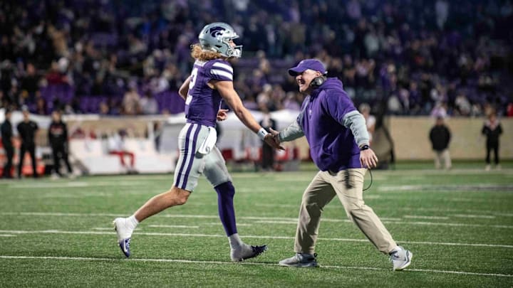 Nov. 23, 2024: Kansas State head coach Chris Klieman greets quarterback Avery Johnson (2) as he makes his way off the field in Kansas State's game against Cincinnati at Bill Snyder Family Stadium in Manhattan, Kansas. 