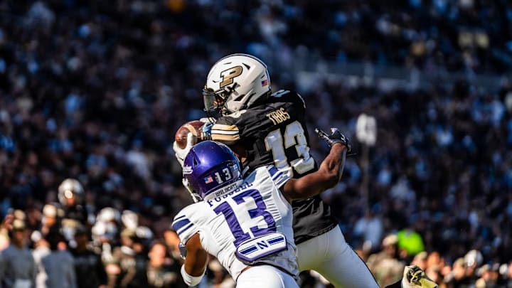 Jaron Tibbs (13) makes the grab against a Northwestern defender during a Big 10 matchup between the Purdue Boilermakers and the Northwestern Wildcats on Saturday, Nov. 2, 2024 in West Lafayette, Ind. at Ross-Ade Stadium. Mandatory Credit: Arshon Bozorgi | The Exponent