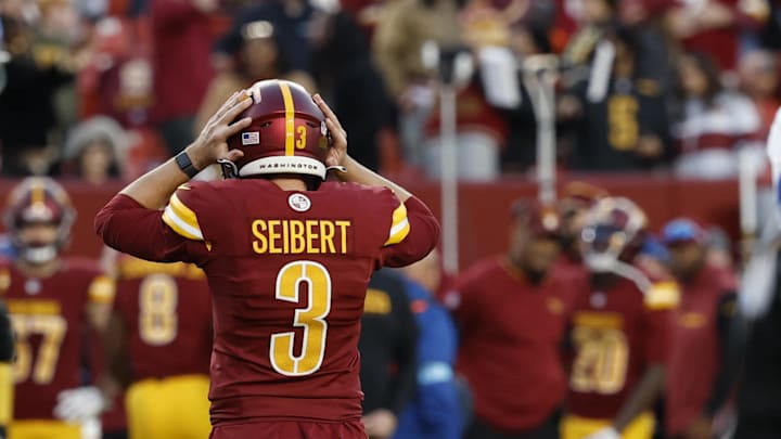 Nov 24, 2024; Landover, Maryland, USA; Washington Commanders place kicker Austin Seibert (3) reacts after missing a potential game-tying extra point in the final minute against the Dallas Cowboys during the fourth quarter at Northwest Stadium. Mandatory Credit: Geoff Burke-Imagn Images