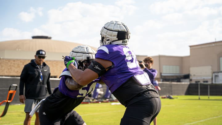 Defensive Coordinator Andy Avalos watches Quinton Harris and Markis Deal during a blocking drill. Defensive Coordinator Andy Avalos watches Quinton Harris and Markis Deal during a blocking drill.