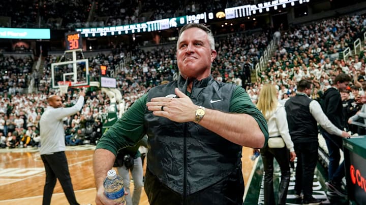 Michigan State's new football coach Pat Fitzgerald pats his heart at the crowd in attendance for the Spartans basketball game against Iowa on Tuesday, Dec. 2, 2025, at the Breslin Center in East Lansing.