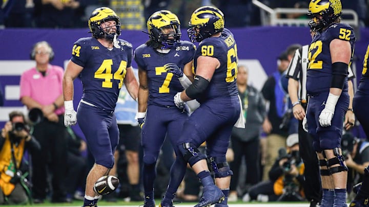 Michigan running back Donovan Edwards celebrates a touchdown against Washington during the first