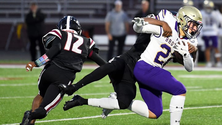 Austin Ariola (22) runs the ball for the CBA-Syracuse in last season's Class AA regional final against the Elmira Express. The Brothers won that game, 63-12.