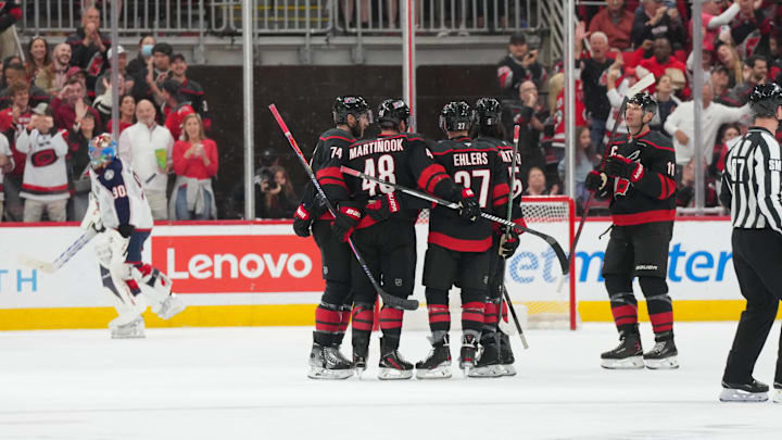 Apr 2, 2026; Raleigh, North Carolina, USA;  Carolina Hurricanes left wing Jordan Martinook (48) celebrates his goal with left wing Nikolaj Ehlers (27) defenseman Jalen Chatfield (5) center Jordan Staal (11)and  defenseman Jaccob Slavin (74) against the Columbus Blue Jackets during the second period at Lenovo Center. Mandatory Credit: James Guillory-Imagn Images