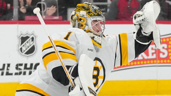 Apr 7, 2026; Raleigh, North Carolina, USA;  Boston Bruins goaltender Jeremy Swayman (1) makes a glove save against the Carolina Hurricanes during the first period at Lenovo Center. Mandatory Credit: James Guillory-Imagn Images