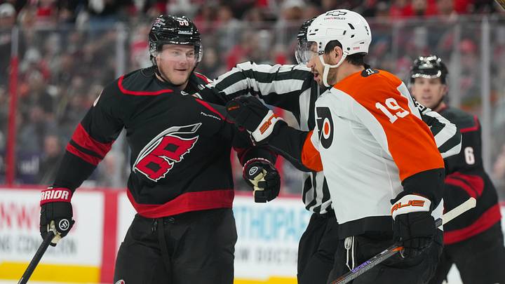 May 2, 2026; Raleigh, North Carolina, USA;  Carolina Hurricanes left wing Eric Robinson (50) and Philadelphia Flyers right wing Garnet Hathaway (19) battle during the first period at Lenovo Center.
