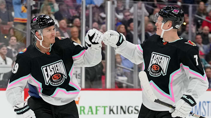 Feb 4, 2023; Sunrise, Florida, USA; Atlantic Division forward Matthew Tkachuk (19) of the Florida Panthers fist bumps Atlantic Division forward Brady Tkachuk (71) of the Ottawa Senators during the second period of a semifinal game during the 2023 NHL All-Star Game at FLA Live Arena. Mandatory Credit: Jasen Vinlove-Imagn Images