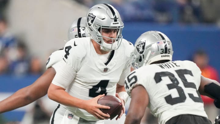 Las Vegas Raiders quarterback Aidan O'Connell (4) turns to hand the ball to Las Vegas Raiders running back Zamir White (35) on Sunday, Dec. 31, 2023, during a game against the Las Vegas Raiders at Lucas Oil Stadium in Indianapolis. Las Vegas Raiders quarterback Aidan O'Connell (4) turns to hand the ball to Las Vegas Raiders running back Zamir White (35) on Sunday, Dec. 31, 2023, during a game against the Las Vegas Raiders at Lucas Oil Stadium in Indianapolis.