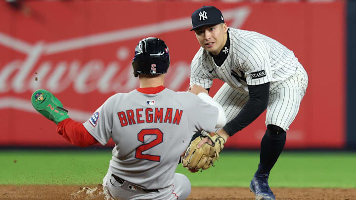 Oct 2, 2025; Bronx, New York, USA; Boston Red Sox third baseman Alex Bregman (2) is forced out by New York Yankees shortstop Anthony Volpe (11) at second base in the ninth inning during game three of the Wildcard round for the 2025 MLB playoffs at Yankee Stadium. Mandatory Credit: Vincent Carchietta-Imagn Images