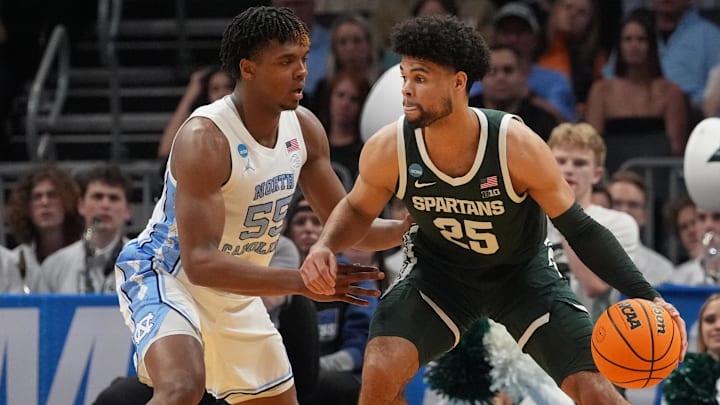 March 23, 2024, Charlotte, NC, USA; Michigan State Spartans forward Malik Hall (25) dribbles against North Carolina Tar Heels forward Harrison Ingram (55)  in the second round of the 2024 NCAA Tournament at the Spectrum Center. Mandatory Credit: Jim Dedmon-Imagn Images