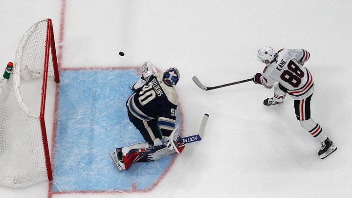 Dec 29, 2019; Columbus, Ohio, USA; Chicago Blackhawks right wing Patrick Kane (88) lifts the puck over Columbus Blue Jackets goalie Elvis Merzlikins (90) for a goal during the shootout at Nationwide Arena. Mandatory Credit: Russell LaBounty-USA TODAY Sports