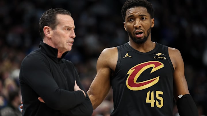 Jan 18, 2025; Minneapolis, Minnesota, USA; Cleveland Cavaliers guard Donovan Mitchell (45) talks with head coach Kenny Atkinson during the second quarter against the Minnesota Timberwolves at Target Center. Mandatory Credit: Matt Krohn-Imagn Images