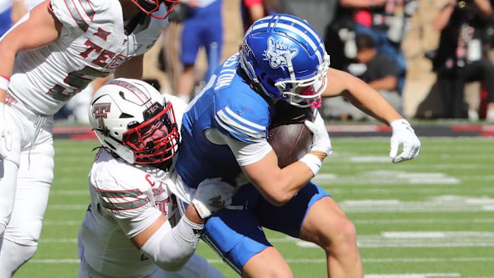 Nov 8, 2025; Lubbock, Texas, USA;  Brigham Young Cougars wide receiver parker Kingston (11) is tackled by Texas Tech Red Raiders defensive back Jacob Rodriguez (10) in the first half at Jones AT&T Stadium. Mandatory Credit: Michael C. Johnson-Imagn Images