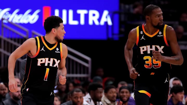Dec 27, 2023; Houston, Texas, USA; Phoenix Suns guard Devin Booker (1) and Phoenix Suns forward Kevin Durant (35) react after a made basket against the Houston Rockets during the second quarter at Toyota Center. Mandatory Credit: Erik Williams-Imagn Images