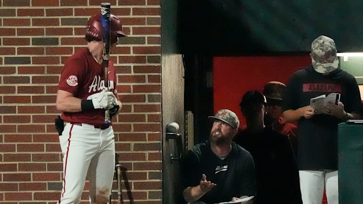 Apr 24, 2025; Tuscaloosa, AL, USA; Alabama head coach Rob Vaughn talks to Alabama infielder Garrett Staton (27) who is on deck to hit against Missouri at Sewell-Thomas Stadium.