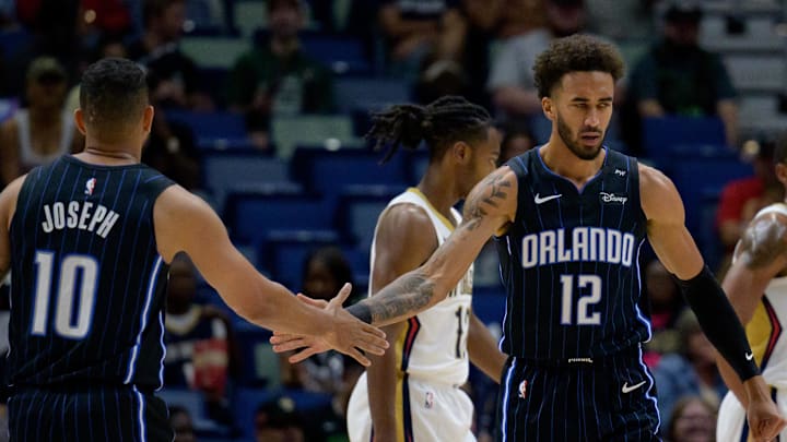 Orlando Magic guard Trevelin Queen (12) celebrates a basket with Orlando Magic guard Cory Joseph (10) against the New Orleans Pelicans during the second half at Smoothie King Center.