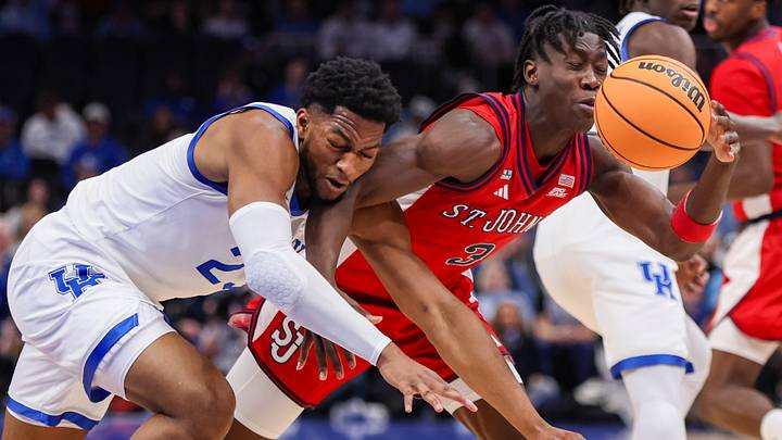 Dec 20, 2025; Atlanta, Georgia, USA; Kentucky Wildcats forward Mouhamed Dioubate (23) and St. John Red Storm guard Joson Sanon (3) reach for a loose ball in the first half at State Farm Arena. Mandatory Credit: Brett Davis-Imagn Images Dec 20, 2025; Atlanta, Georgia, USA; Kentucky Wildcats forward Mouhamed Dioubate (23) and St. John Red Storm guard Joson Sanon (3) reach for a loose ball in the first half at State Farm Arena. Mandatory Credit: Brett Davis-Imagn Images