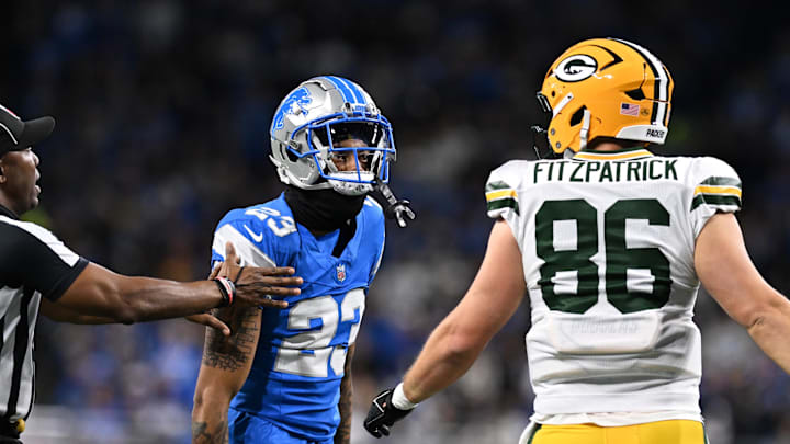 Dec 5, 2024; Detroit, Michigan, USA;  Detroit Lions cornerback Carlton Davis III (23) and Green Bay Packers tight end John FitzPatrick (86) exchange words in the second quarter at Ford Field. Mandatory Credit: Lon Horwedel-Imagn Images