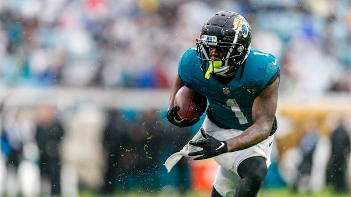 Dec 29, 2024; Jacksonville, Florida, USA; Jacksonville Jaguars running back Travis Etienne Jr. (1) runs the ball against the Tennessee Titans during the second quarter at EverBank Stadium. Mandatory Credit: Morgan Tencza-Imagn Images