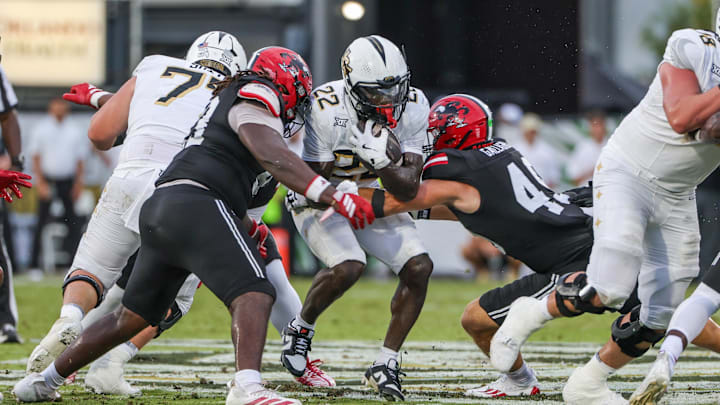 Aug 28, 2025; Orlando, Florida, USA; UCF Knights running back Myles Montgomery (22) is tackled by Jacksonville State Gamecocks linebacker Thaxton Gallagher (49) during the first quarter at Acrisure Bounce House. Mandatory Credit: Mike Watters-Imagn Images Aug 28, 2025; Orlando, Florida, USA; UCF Knights running back Myles Montgomery (22) is tackled by Jacksonville State Gamecocks linebacker Thaxton Gallagher (49) during the first quarter at Acrisure Bounce House. Mandatory Credit: Mike Watters-Imagn Images