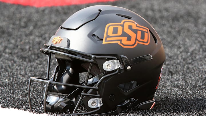 Oct 25, 2025; Lubbock, Texas, USA; A general view of an Oklahoma State Cowboys helmet on the field before the game against the Texas Tech Red Raiders at Jones AT&T Stadium. Mandatory Credit: Michael C. Johnson-Imagn Images Oct 25, 2025; Lubbock, Texas, USA; A general view of an Oklahoma State Cowboys helmet on the field before the game against the Texas Tech Red Raiders at Jones AT&T Stadium. Mandatory Credit: Michael C. Johnson-Imagn Images
