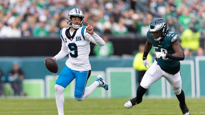 Dec 8, 2024; Philadelphia, Pennsylvania, USA;  Carolina Panthers quarterback Bryce Young (9) runs with the ball past Philadelphia Eagles linebacker Jalyx Hunt (58) during the second quarter at Lincoln Financial Field. Mandatory Credit: Bill Streicher-Imagn Images