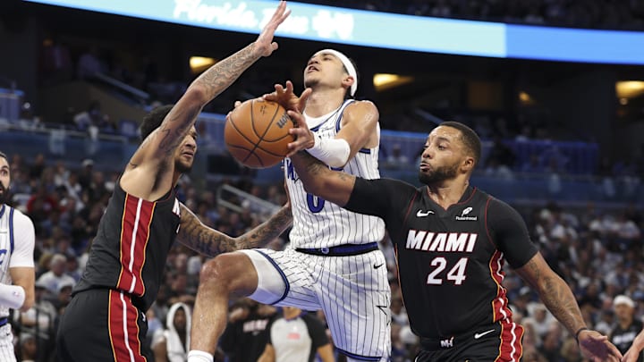 Oct 22, 2025; Orlando, Florida, USA; Miami Heat guard Norman Powell (24) strips the ball from Orlando Magic guard Anthony Black (0) in the fourth quarter at Kia Center. Mandatory Credit: Nathan Ray Seebeck-Imagn Images