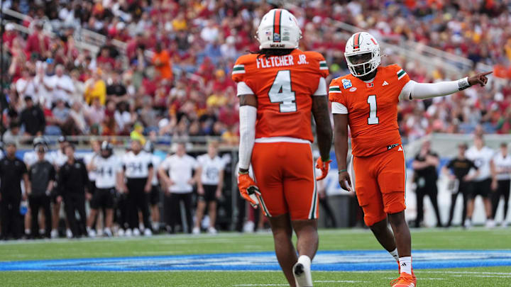 Dec 28, 2024; Orlando, FL, USA; Miami Hurricanes quarterback Cam Ward (1) celebrates the touchdown against the Iowa State Cyclones during the first half at Camping World Stadium. Mandatory Credit: Jasen Vinlove-Imagn Images
