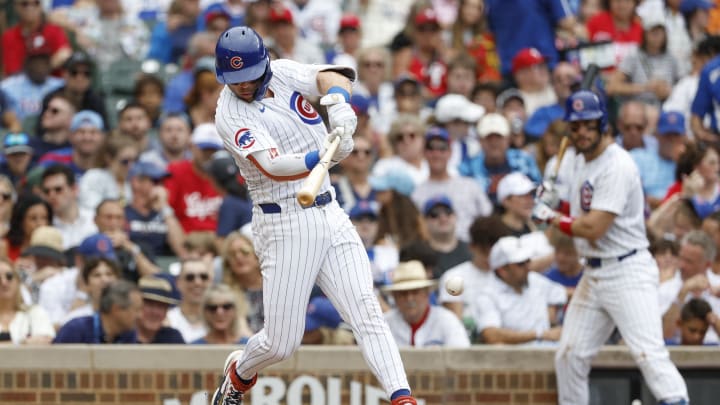 Jul 4, 2024; Chicago, Illinois, USA; Chicago Cubs second baseman Nico Hoerner (2) hits an RBI-single against the Philadelphia Phillies during the fourth inning at Wrigley Field. Mandatory Credit: Kamil Krzaczynski-USA TODAY Sports