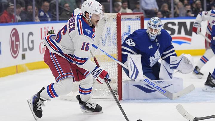 Mar 25, 2026; Toronto, Ontario, CAN; New York Rangers forward Vincent Trocheck (16) looks to pass the puck as Toronto Maple Leafs goaltender Joseph Woll (60) defends the goal during the second period at Scotiabank Arena. Mandatory Credit: John E. Sokolowski-Imagn Images
