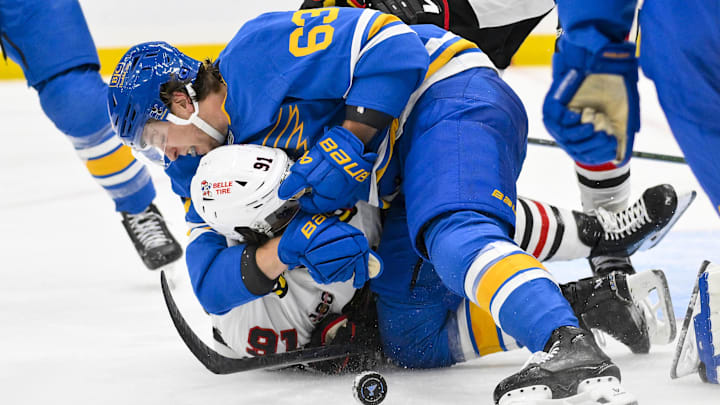 Oct 15, 2025; St. Louis, Missouri, USA; St. Louis Blues left wing Jake Neighbours (63) fights Chicago Blackhawks center Frank Nazar (91) after he scored and collided with goaltender Joel Hofer (not pictured) during the second period at Enterprise Center. Mandatory Credit: Jeff Curry-Imagn Images