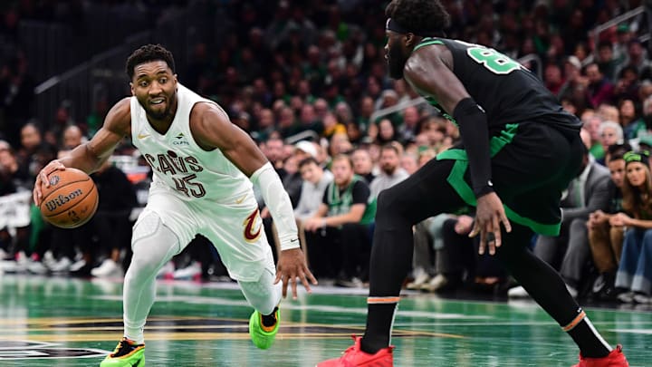 Cleveland Cavaliers guard Donovan Mitchell controls the ball while Boston Celtics center Neemias Queta.