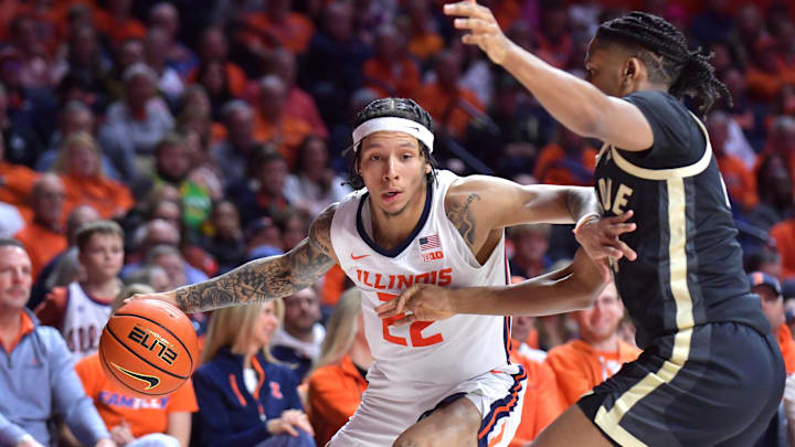Mar 7, 2025; Champaign, Illinois, USA;  Illinois Fighting Illini guard Tre White (22) drives the ball against Purdue Boilermakers guard C.J. Cox (0) during the first half at State Farm Center. Mandatory Credit: Ron Johnson-Imagn Images