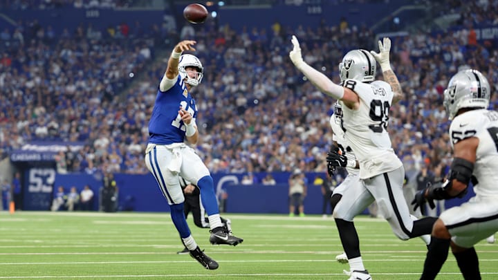 Oct 5, 2025; Indianapolis, Indiana, USA; Indianapolis Colts quarterback Daniel Jones (17) throws a touchdown pass against the Las Vegas Raiders during the second quarter at Lucas Oil Stadium. Mandatory Credit: Trevor Ruszkowski-Imagn Images
