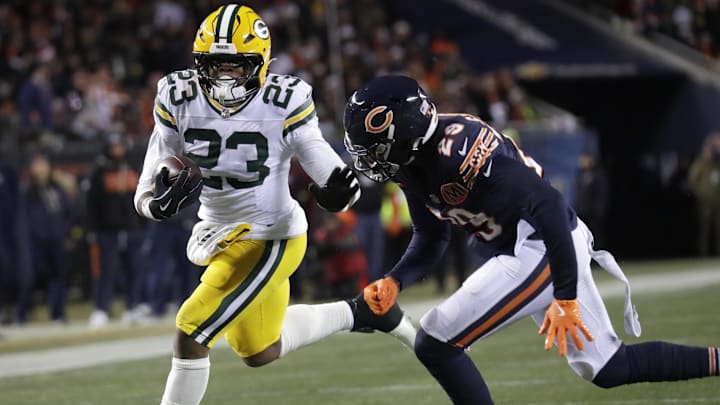 Packers running back Emanuel Wilson tries to escape a tackle attempt by Bears cornerback Tyrique Stevenson.