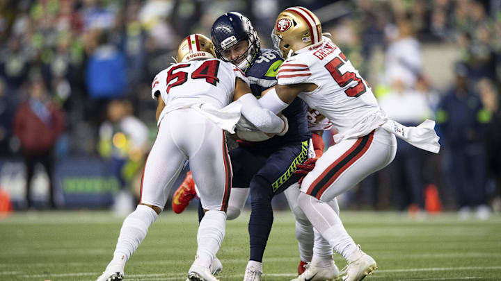 Dec 29, 2019; Seattle, Washington, USA; San Francisco 49ers middle linebacker Fred Warner (54) and San Francisco 49ers linebacker Dre Greenlaw (57) tackle Seattle Seahawks tight end Jacob Hollister (48) during the first half at CenturyLink Field. San Francisco defeated Seattle 26-21. Mandatory Credit: Steven Bisig-Imagn Images