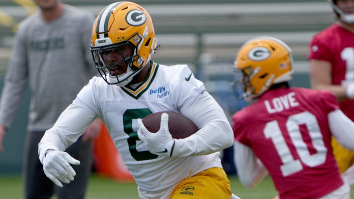 Green Bay Packers running back Josh Jacobs (8) carries the ball during minicamp. 