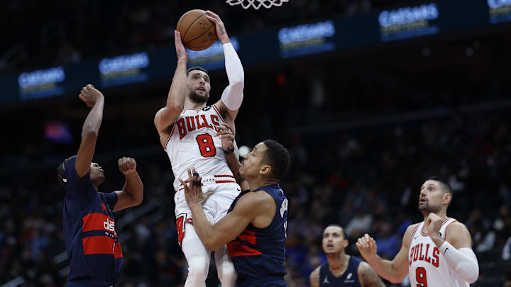  Chicago Bulls guard Zach LaVine (8) shoots the ball as Washington Wizards guard Bilal Coulibaly (0) and Wizards guard Malcolm Brogdon (15) defend in the third quarter at Capital One Arena. Mandatory Credit: Geoff Burke-Imagn Images