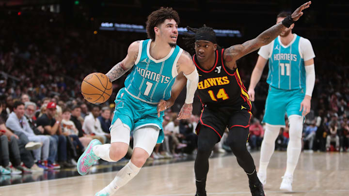 Mar 12, 2025; Atlanta, Georgia, USA; Charlotte Hornets guard LaMelo Ball (1) works past Atlanta Hawks guard Terance Mann (14) during the second half at State Farm Arena. Mandatory Credit: Mady Mertens-Imagn Images