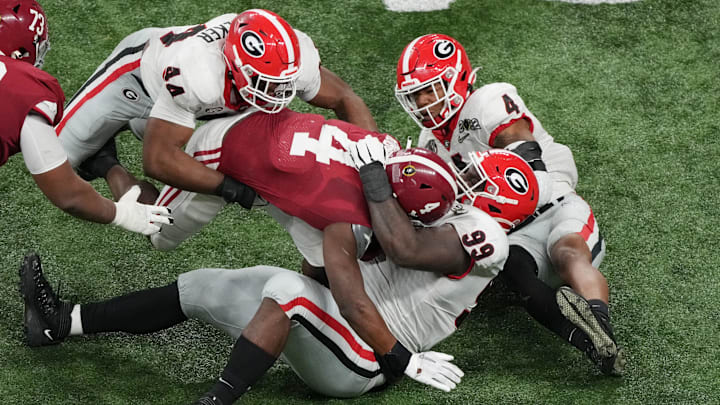 Jan 10, 2022; Indianapolis, IN, USA; Alabama Crimson Tide running back Brian Robinson Jr. (4) is tackled by Georgia Bulldogs defensive lineman Jordan Davis (99) in the fourth quarter during the 2022 CFP college football national championship game at Lucas Oil Stadium. Mandatory Credit: Joshua Bickel-Imagn Images Jan 10, 2022; Indianapolis, IN, USA; Alabama Crimson Tide running back Brian Robinson Jr. (4) is tackled by Georgia Bulldogs defensive lineman Jordan Davis (99) in the fourth quarter during the 2022 CFP college football national championship game at Lucas Oil Stadium. Mandatory Credit: Joshua Bickel-Imagn Images
