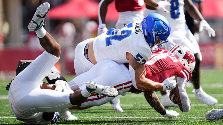 Buffalo linebacker Shaun Dolac (52) takes down Wisconsin running back Braelon Allen (0) during a game on Saturday, September 2, 2023 at Camp Randall Stadium.