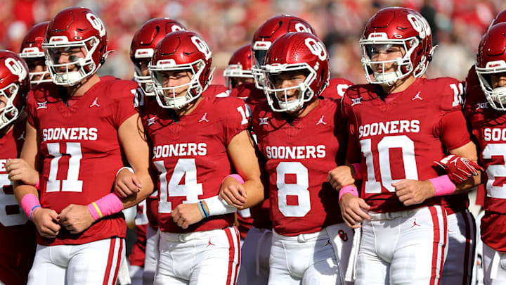 OU's Davis Beville (11), General Booty (14), Oklahoma's Dillon Gabriel (8) and Jackson Arnold (10)