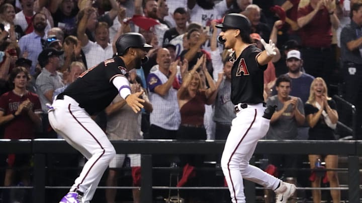 Arizona Diamondbacks center fielder Alek Thomas (right) celebrates with left fielder Lourdes Gurriel