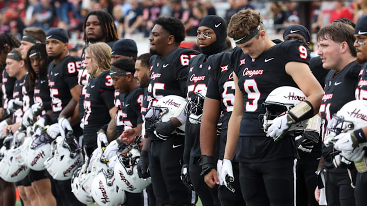 Nov 1, 2025; Houston, Texas, USA; Before the game against the West Virginia Mountaineers Houston Cougars linebacker Corey Platt Jr. (9) stands for a moment of silence for Houston coach Kurt Hester at TDECU Stadium. The Houston Cougars' strength coach who died was Kurt Hester, the Director of Strength and Performance. Hester passed away on October 25, 2025, from stage IV melanoma after an eight-month battle with the diseaseMandatory Credit: Thomas Shea-Imagn Images
