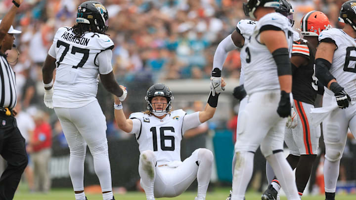 Jacksonville Jaguars quarterback Trevor Lawrence (16) is helped by offensive tackle Anton Harrison (77) and offensive tackle Cam Robinson (74) after being sacked during the third quarter of an NFL football matchup Sunday, Sept. 15, 2024 at EverBank Stadium in Jacksonville, Fla. The Browns defeated the Jaguars 18-13. [Corey Perrine/Florida Times-Union]
