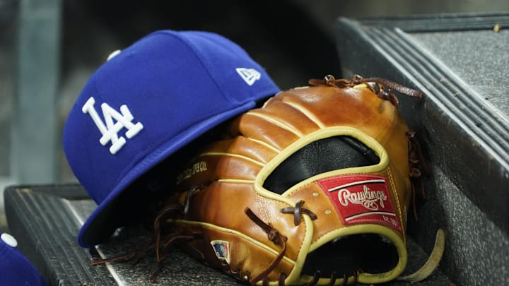 Apr 28, 2024; Toronto, Ontario, CAN; A hat and glove of an Los Angeles Dodgers player durng a game against the Toronto Blue Jays at Rogers Centre. Mandatory Credit: John E. Sokolowski-Imagn Images
