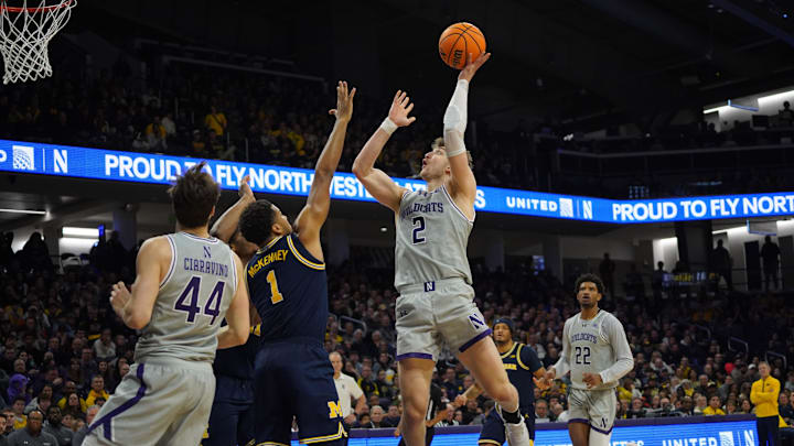 Feb 11, 2026; Evanston, Illinois, USA; Northwestern Wildcats forward Nick Martinelli (2) shoots the ball over Michigan Wolverines guard Trey McKenney (1) during the second half at Welsh-Ryan Arena. Mandatory Credit: David Banks-Imagn Images